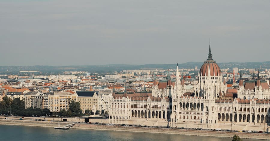 Scenic view of the iconic Hungarian Parliament Building along the Danube River in Budapest.
