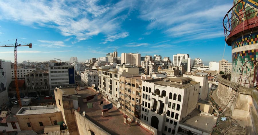 High-angle view of Casablanca's urban skyline under a vibrant blue sky.