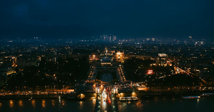 Stunning nighttime aerial cityscape of Paris highlighting iconic landmarks.